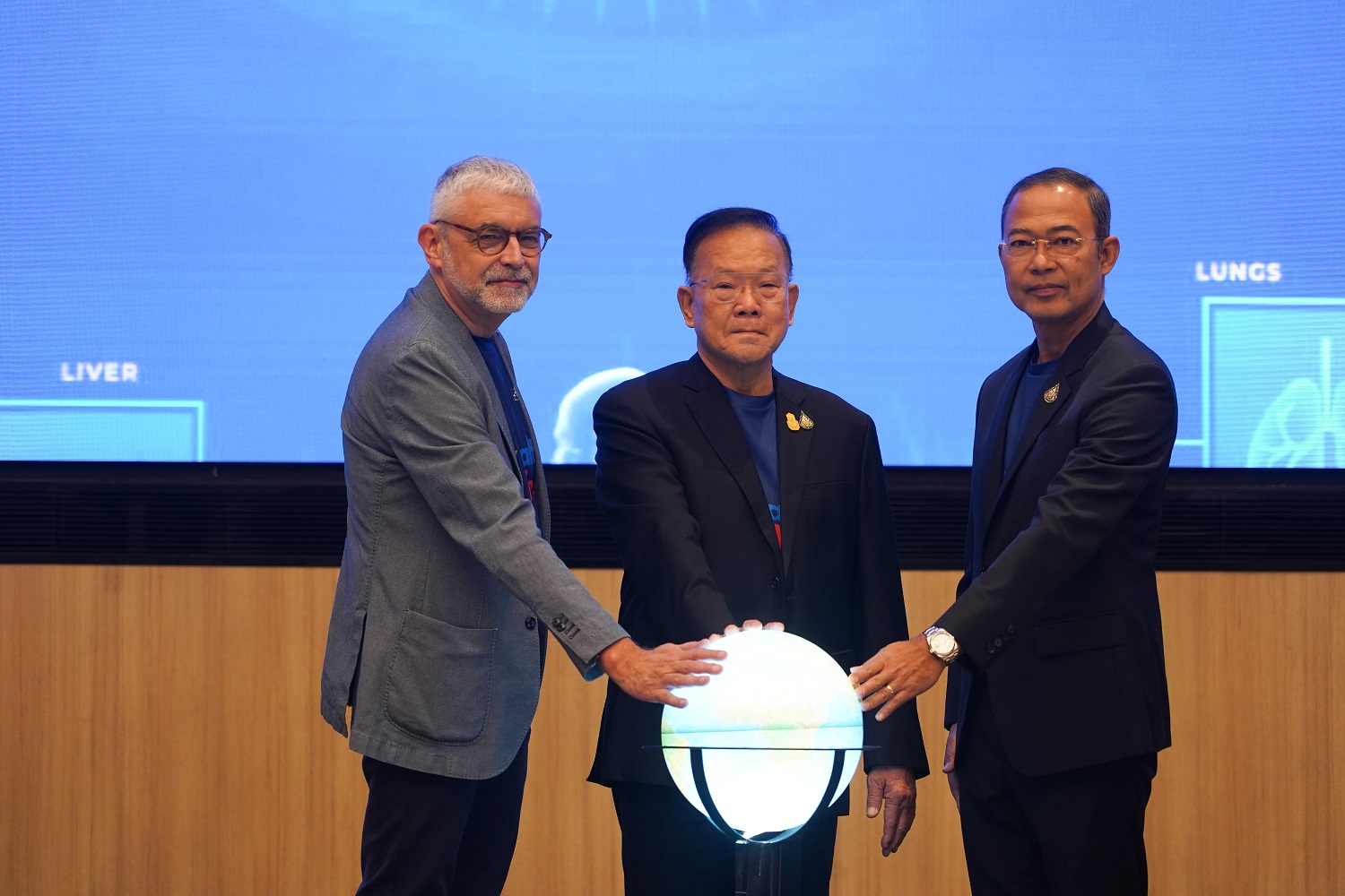 Dr. Jos Vandelaer (WHO Representative to Thailand), Mr. Santi Promphat (Deputy Minister of Public Health), and Dr. Kitisak Aksornwong (Deputy Permanent Secretary) interact with a globe, symbolizing Thailand's commitment to the World Health Day © WHO 2024