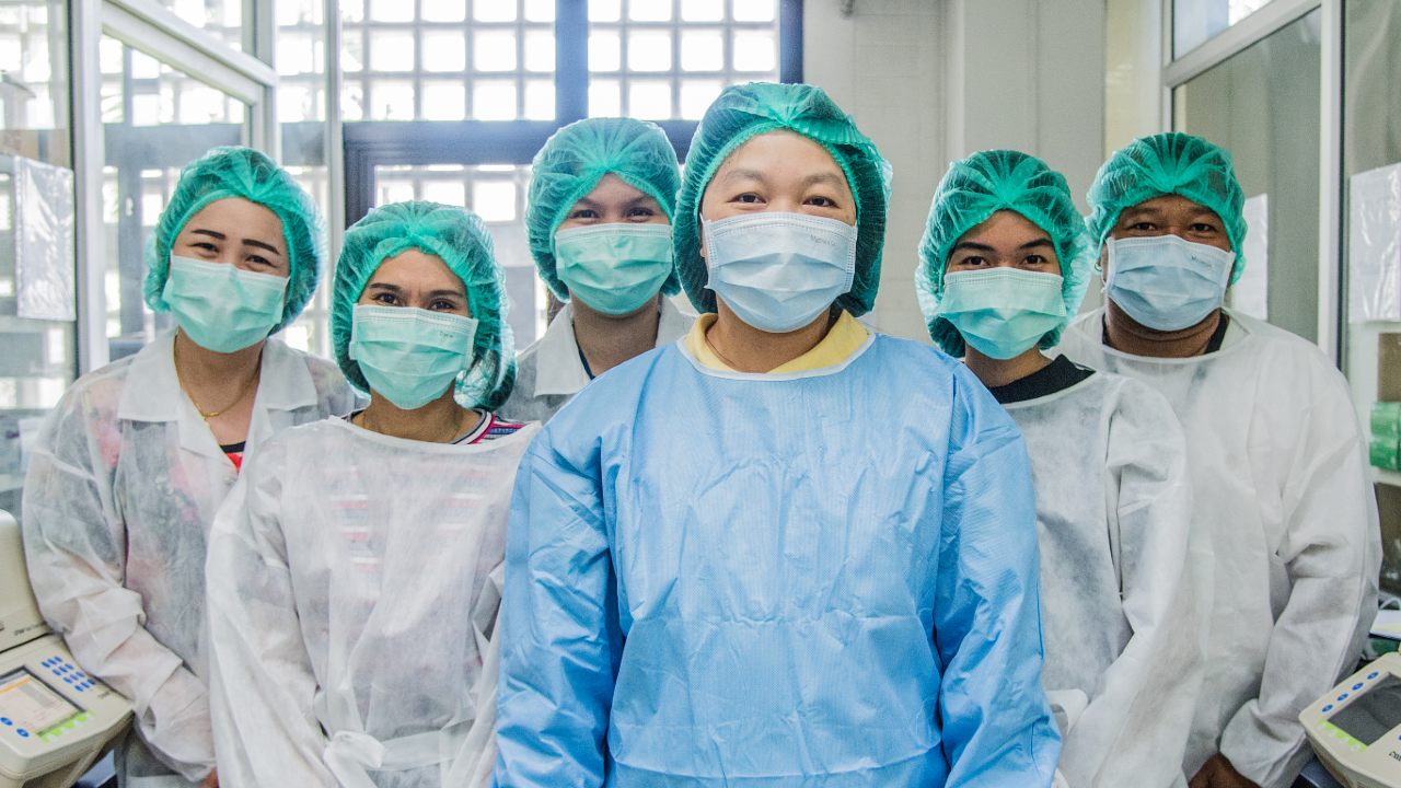 Team of microbiologists pose for a portrait.