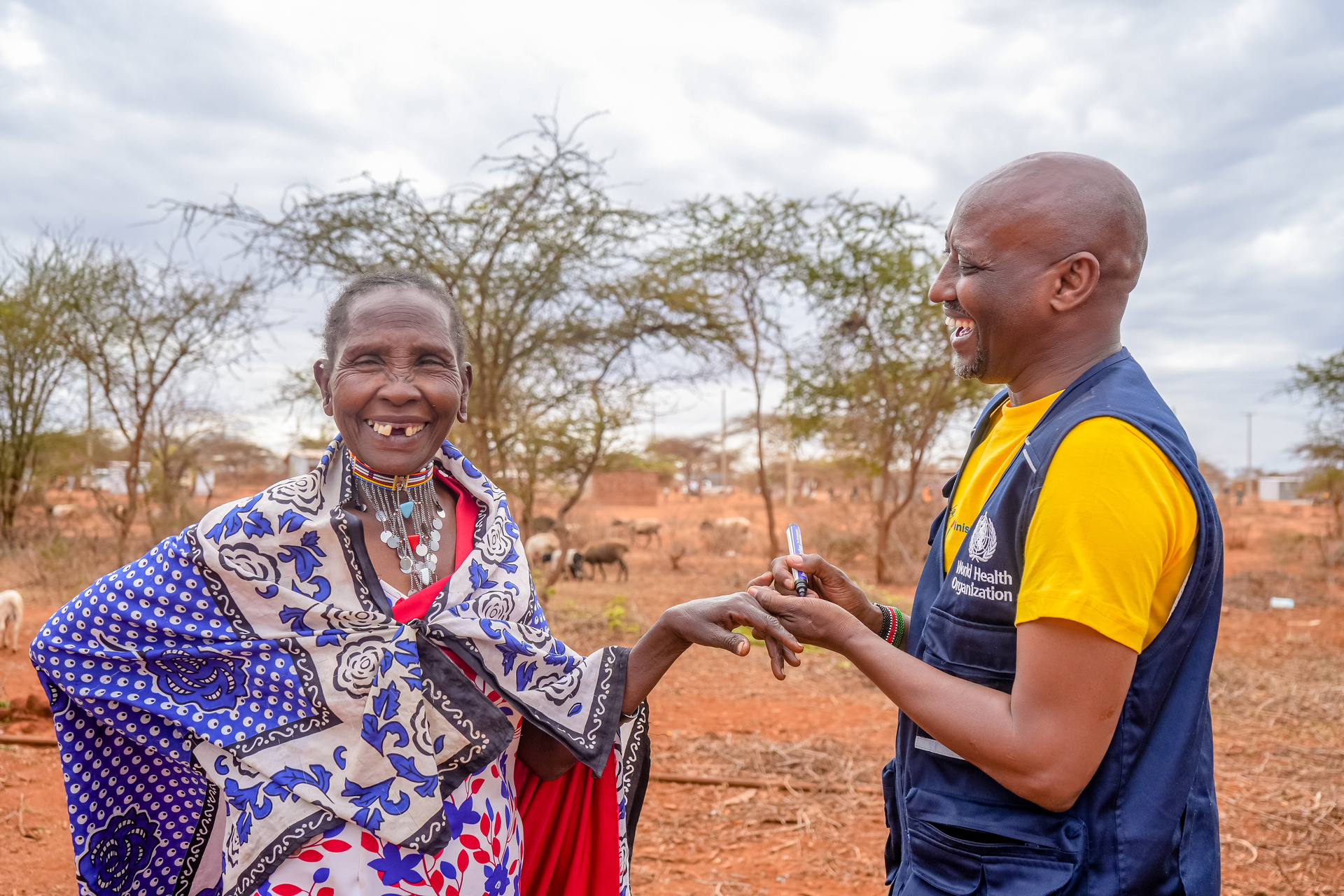 Cholera vaccine Kenya A woman from the local Maasai community laughs when she gets a mark on her finger to indicate that she's received the oral cholera vaccine.