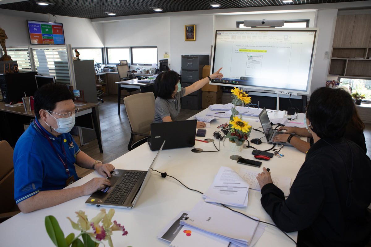 Director of the Ramathibodi Poison Center Dr Winai Wananukul, Charuwan Sriapha, Puangpak Promrungsri and Achara Tongpoo meet in the main office of the centre. © WHO / Amanda Mustard