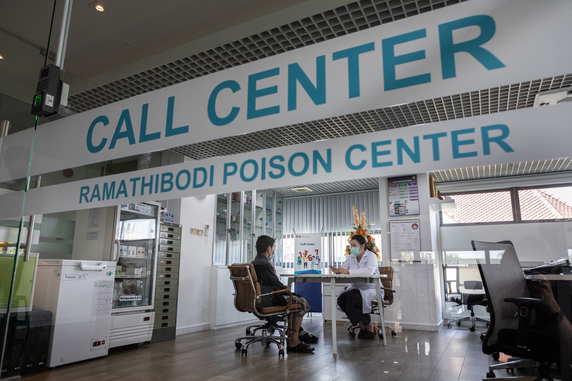 Dr Satariya Trakulsrichai consults with patients at the Ramathibodi Poison Center. © WHO / Amanda Mustard