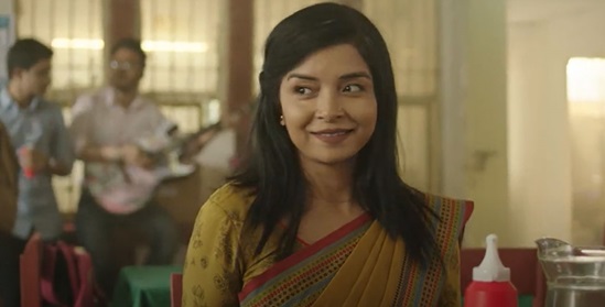 A lady in yellow Sari in a restaurant