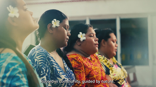 A group of women from the Pacific with a white flower tucked in one of their ears