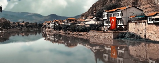 A screenshot showing a Turkish village by a river.