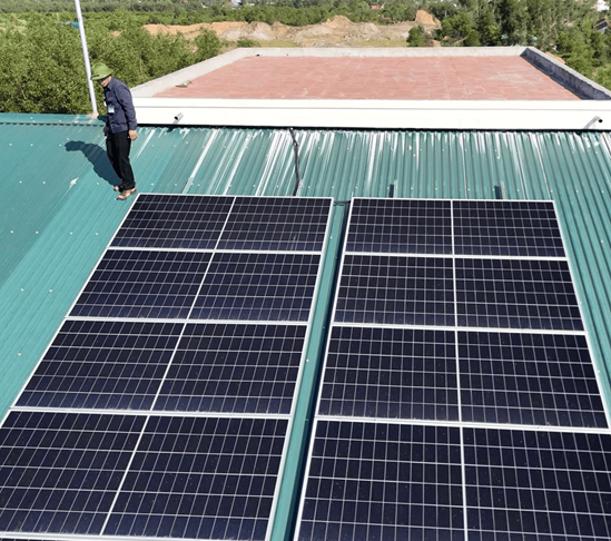 A man walking on a roof with solar panels