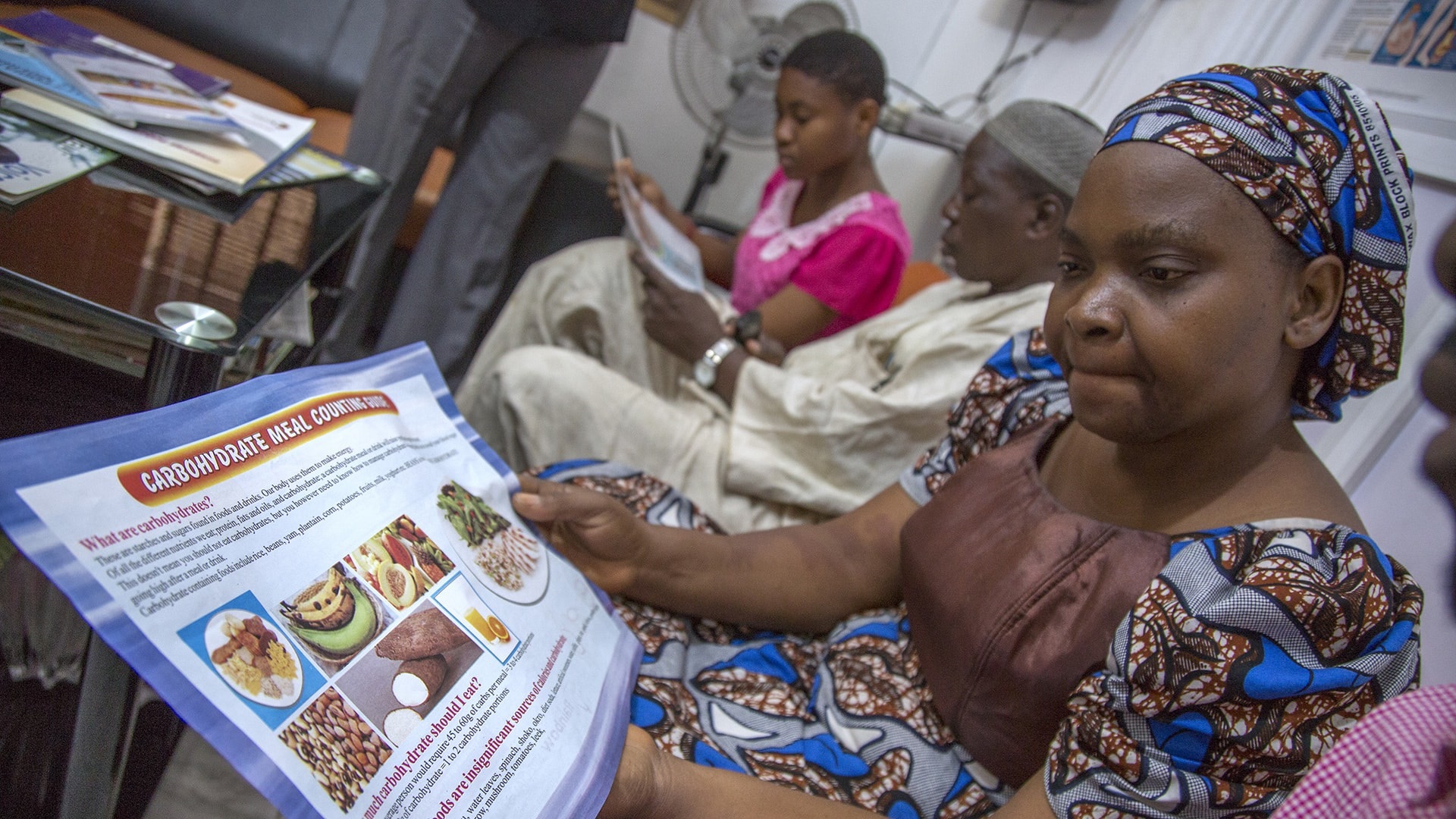 Photo of diabetic patients reading about nutritional information at a medical centre in Lagos.