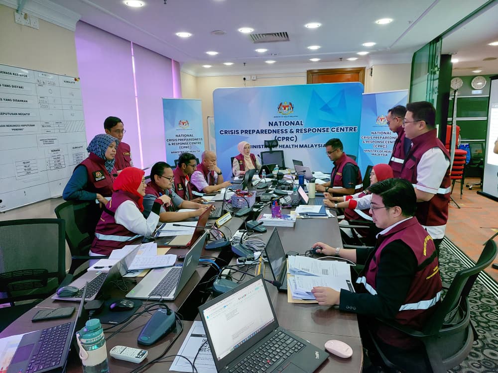 Participants in a simulation exercise sitting around a table discussing data and information