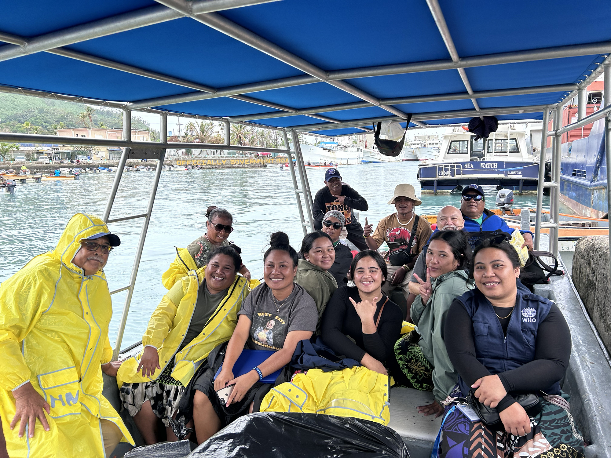 Members of a health outreach team and WHO staff on a boat