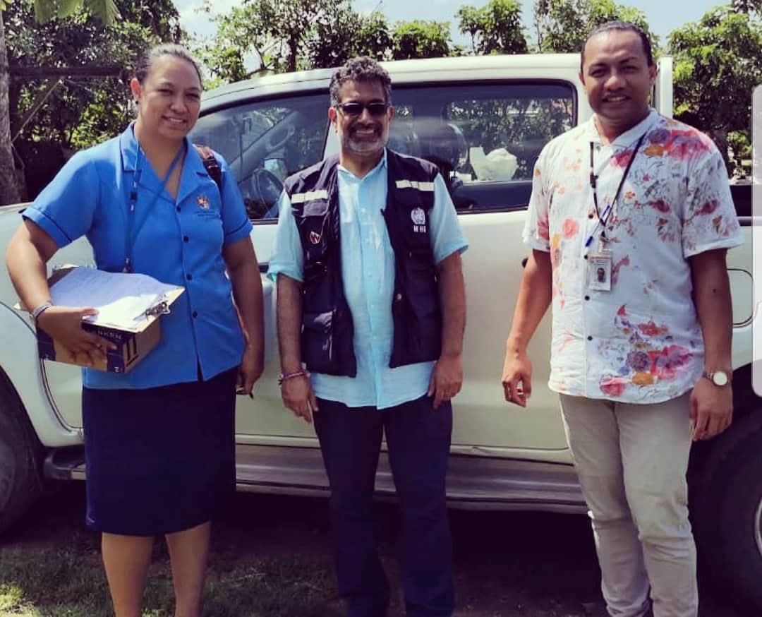 Three healthcare workers conduct a field visit during a measles outbreak in Tonga