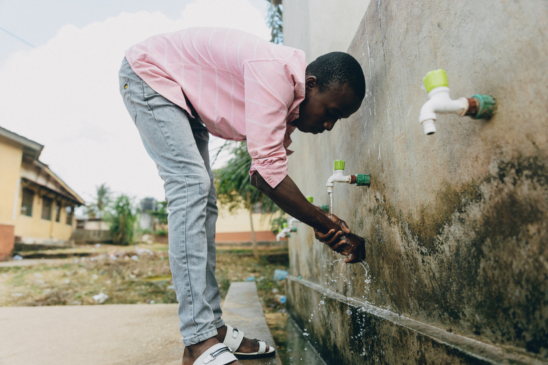 Abdul Zachari, a young man is washing his hands during cholera outbreak