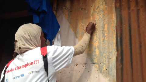 Health worker marking door during the MDA campaign in Ebola hotspot areas in sierra Leone
