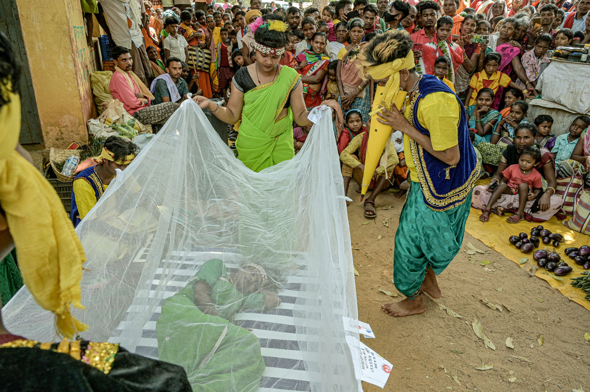 Demonstrating the use of a mosquito net