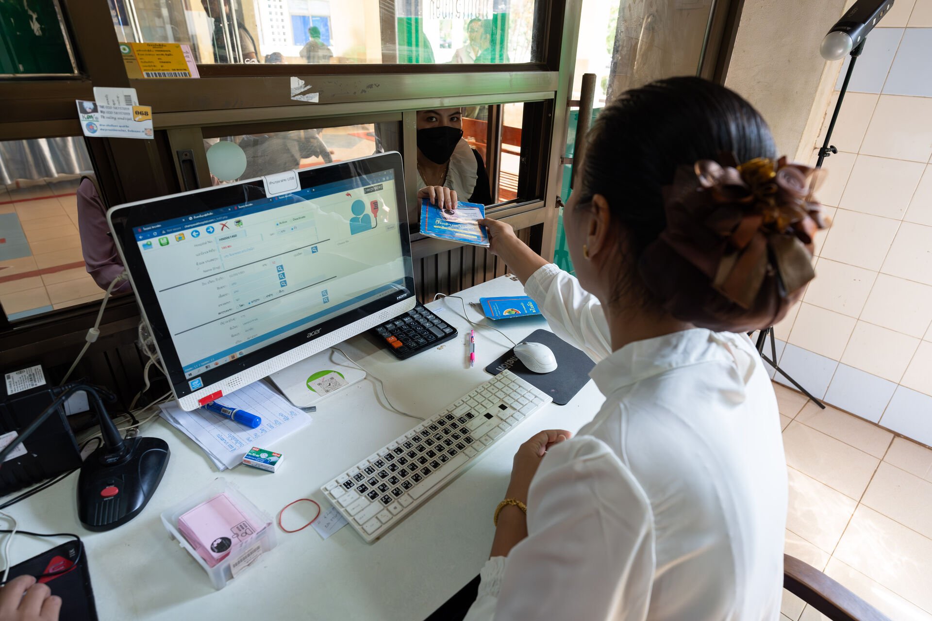 Woman handling over a health insurance card
