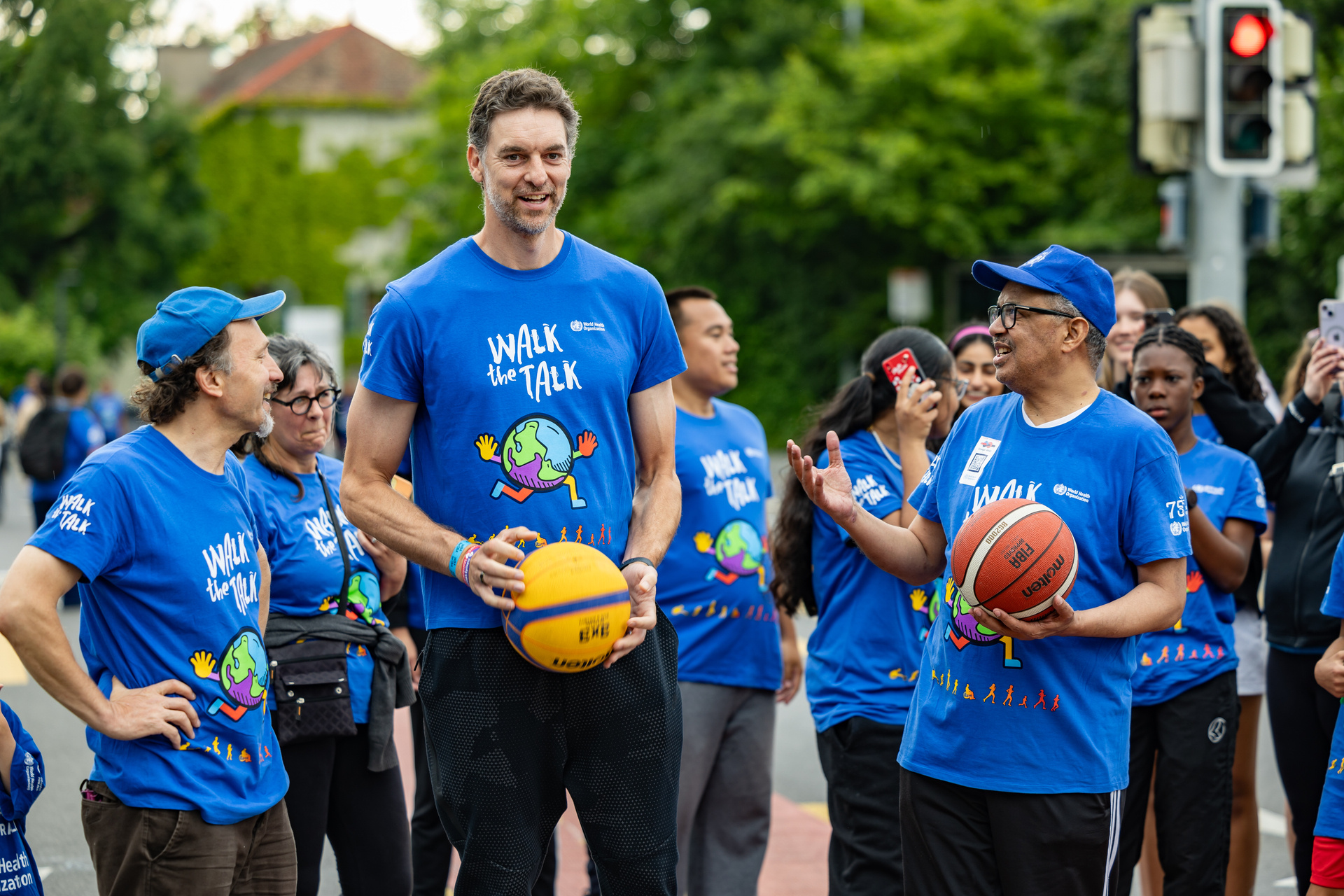 Walk the Talk activity Two smiling men holding basketballs while another looks on