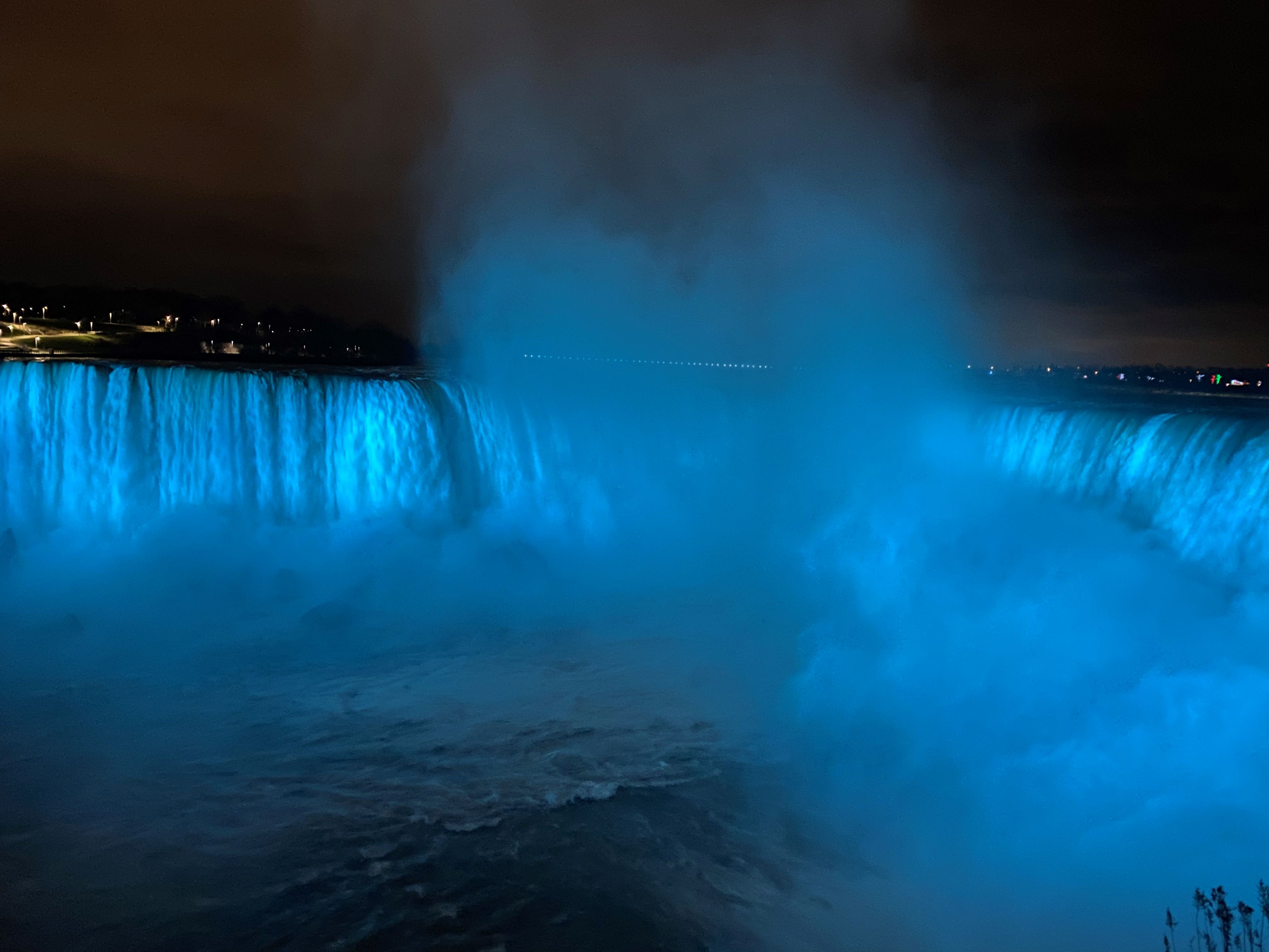 Niagara Falls at night illuminated in teal to mark World Cervical Cancer Elimination Day.