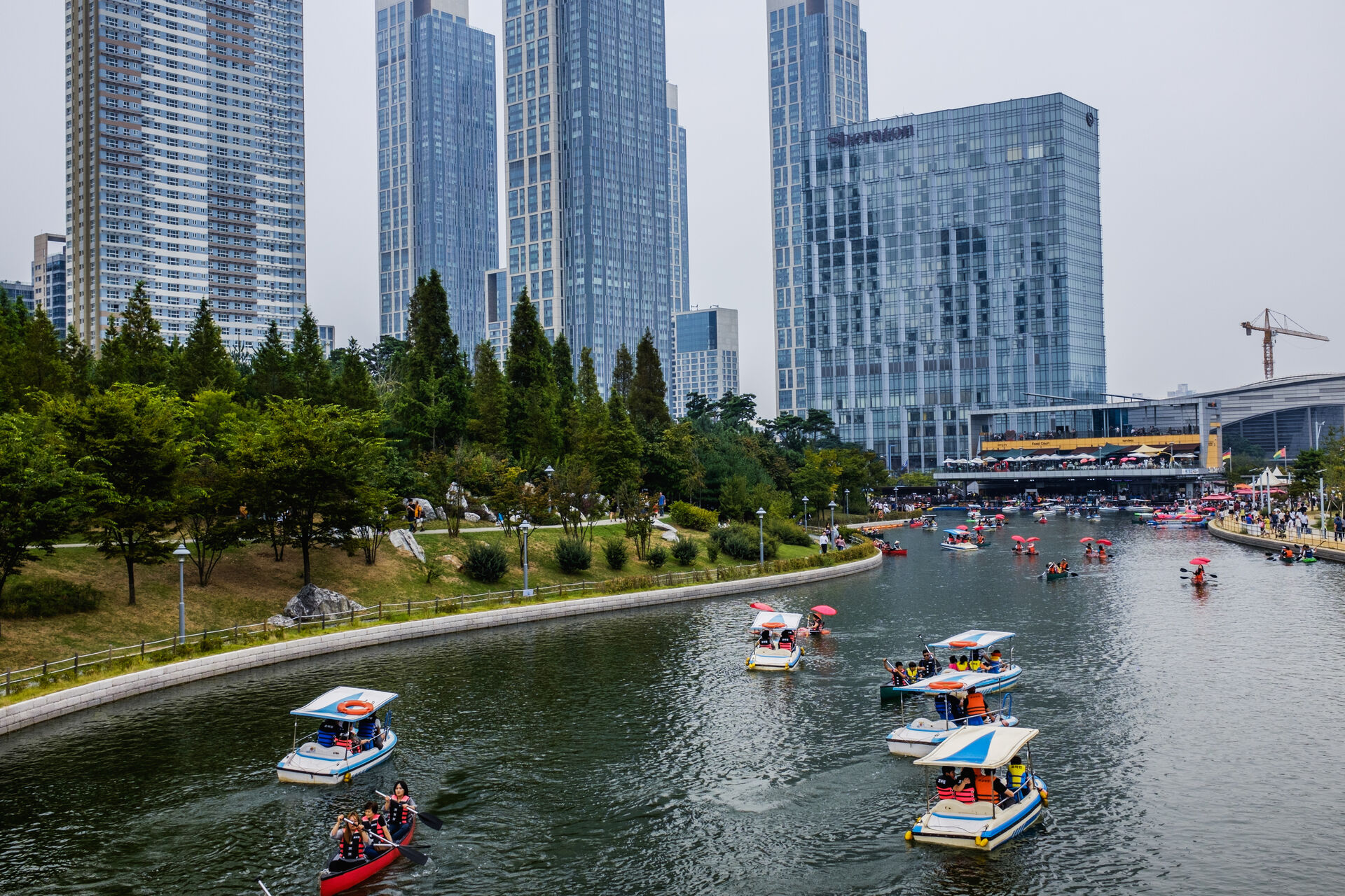 Small boats on water with an urban setting background