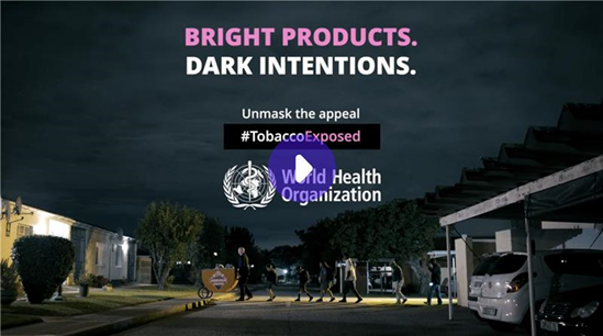 Dark image with people crossing a road and parking with cars