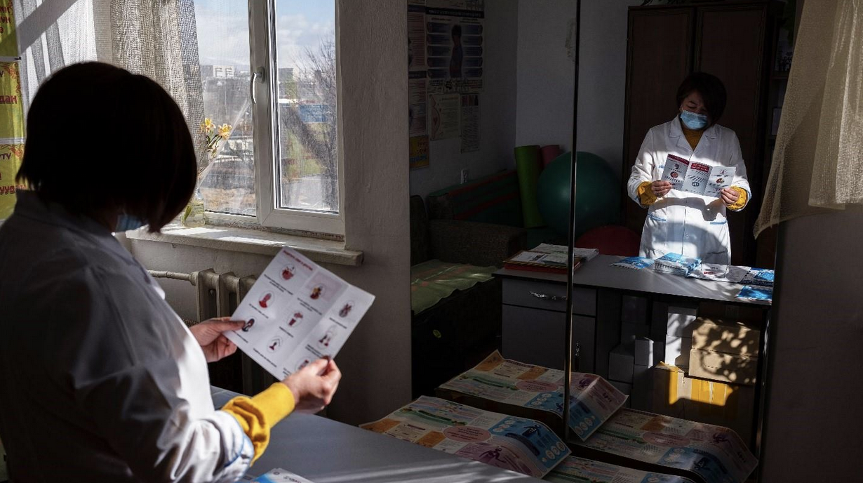 Health care worker reviewing a public health advice leaflet