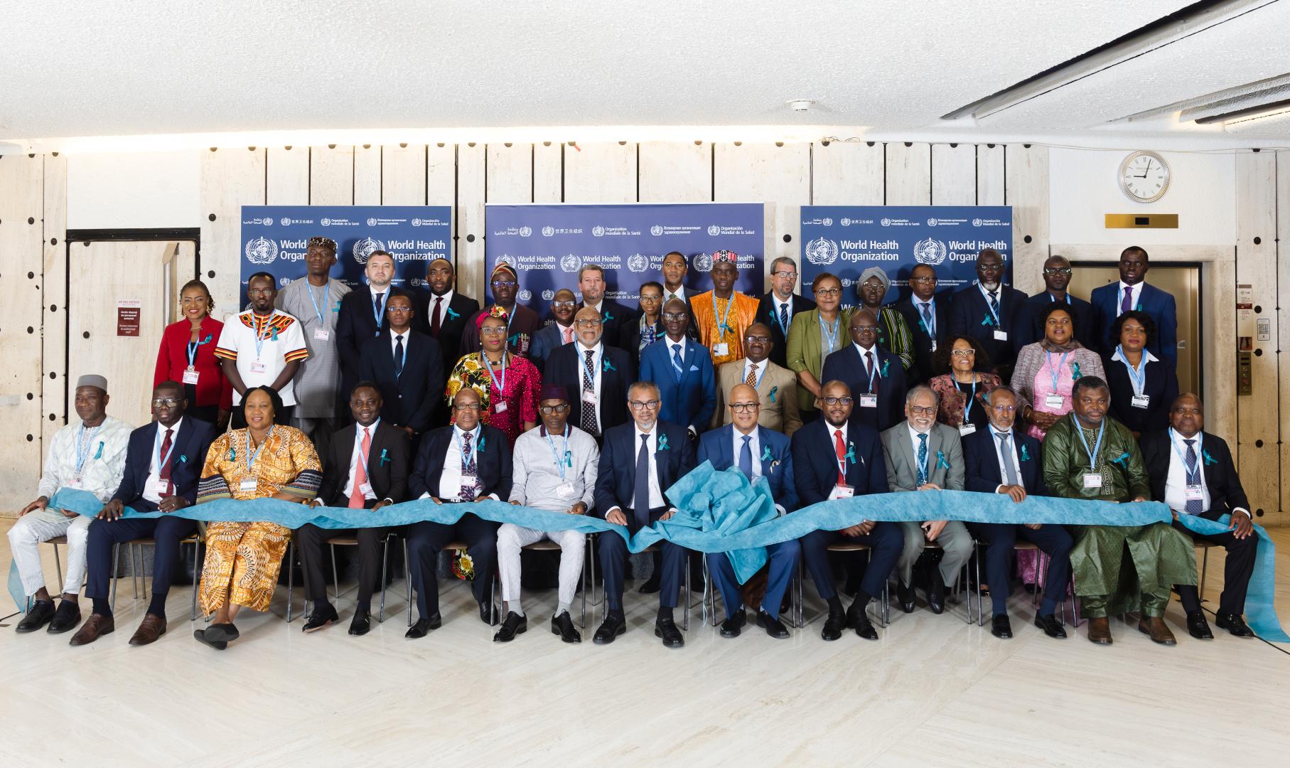WHA78_CervicalCancerDay_MS CoSponsors. A group of people holding a large blue ribbon at Cervical Cancer Day
