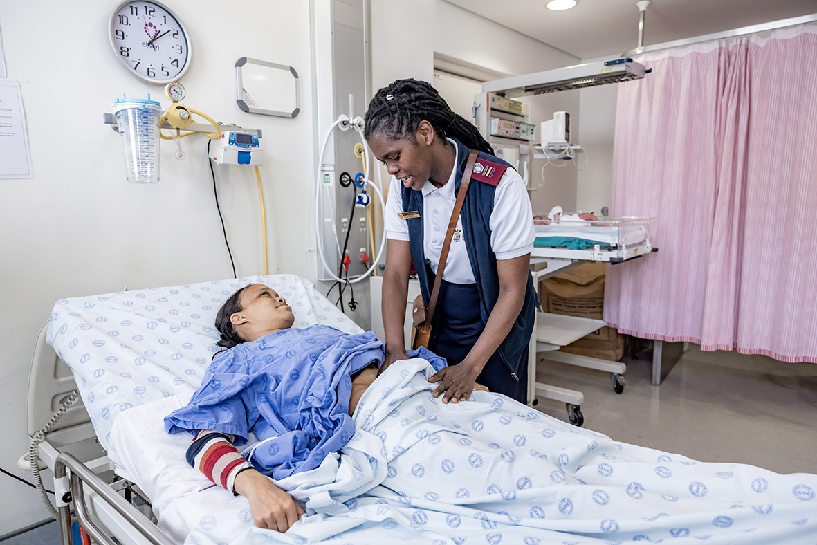 Sr Noxolo Hoga Advanced Midwife examines Zaitoon Ragman and her baby Naa-iqah  (6 days old)  in the labour ward at the Mitchells Plain District Hospital, Cape town South Africa.