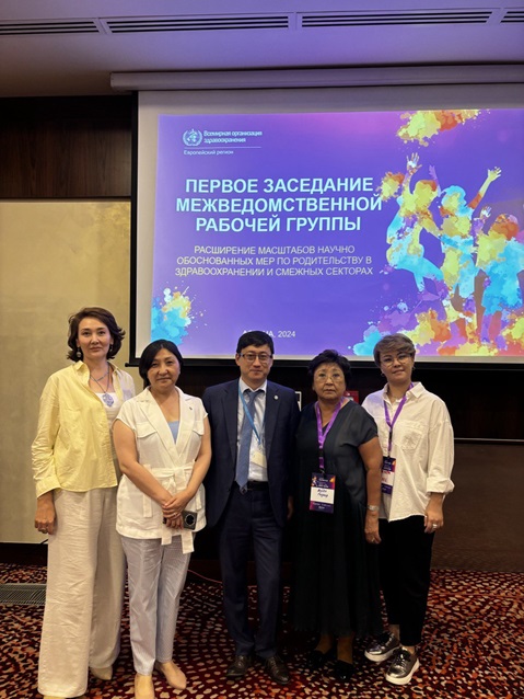 Five people standing in front of a screen
