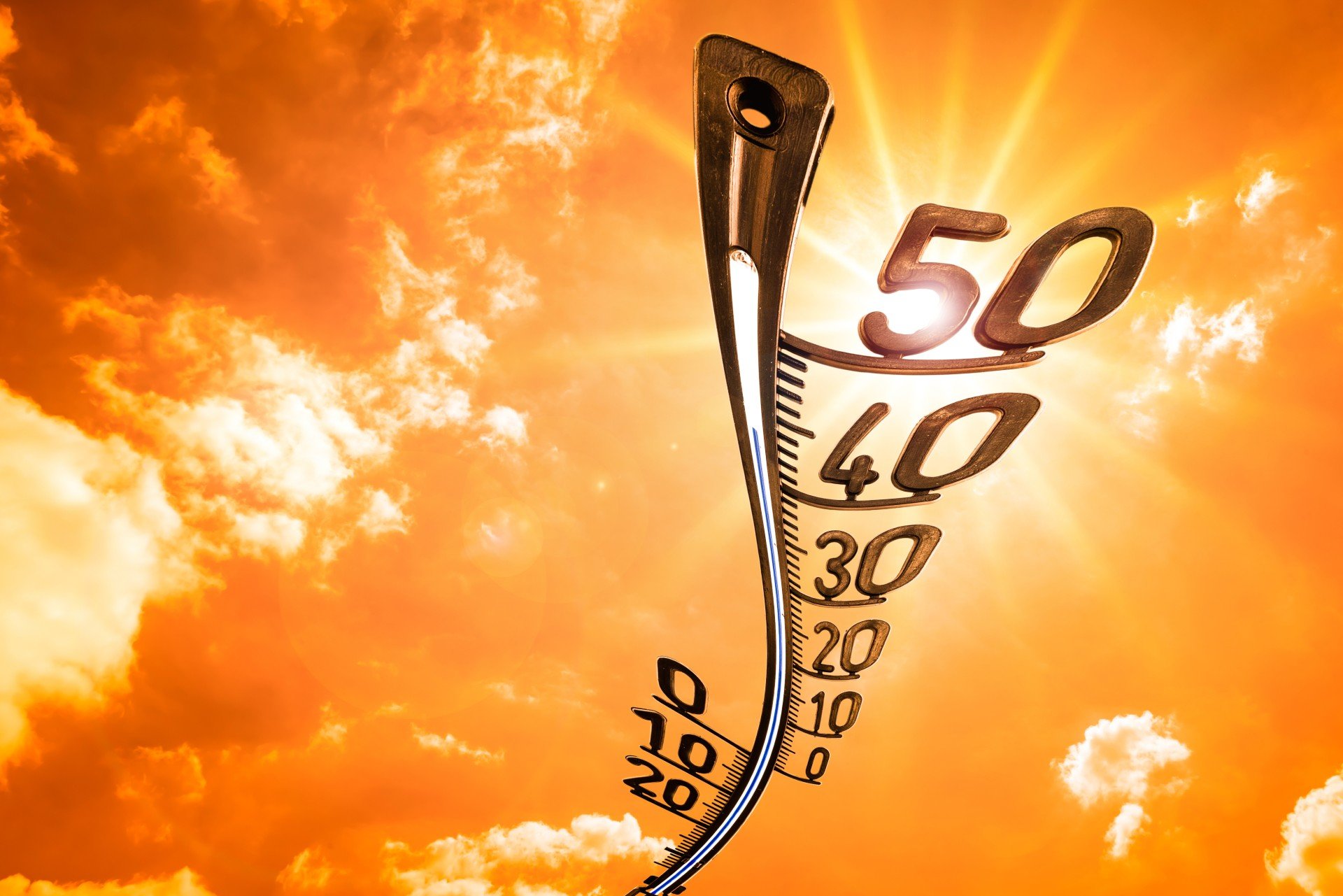 thermometer on orange sky background