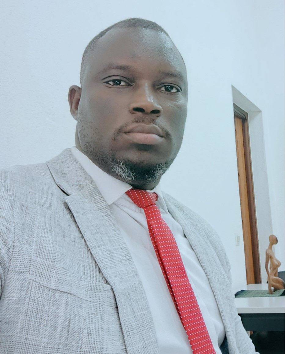 Man with grey suit and red tie looking into the camera