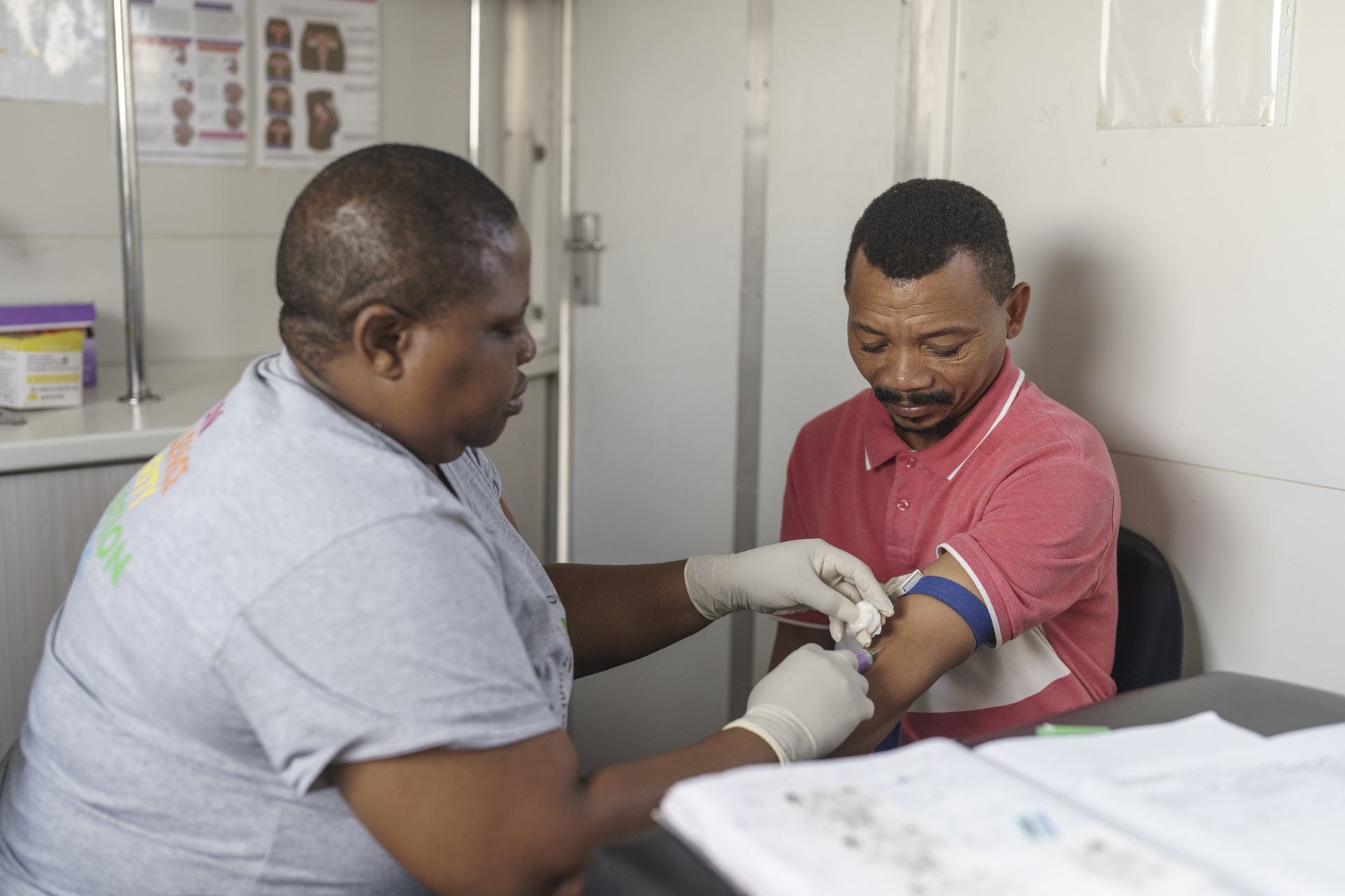 Nurse takes a blood sample from patient