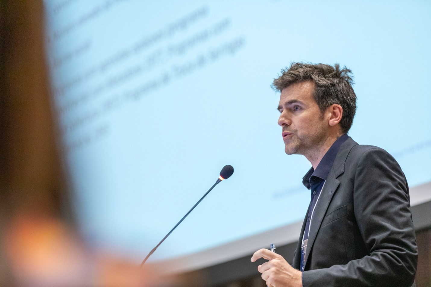 Man in suit addressing an audience