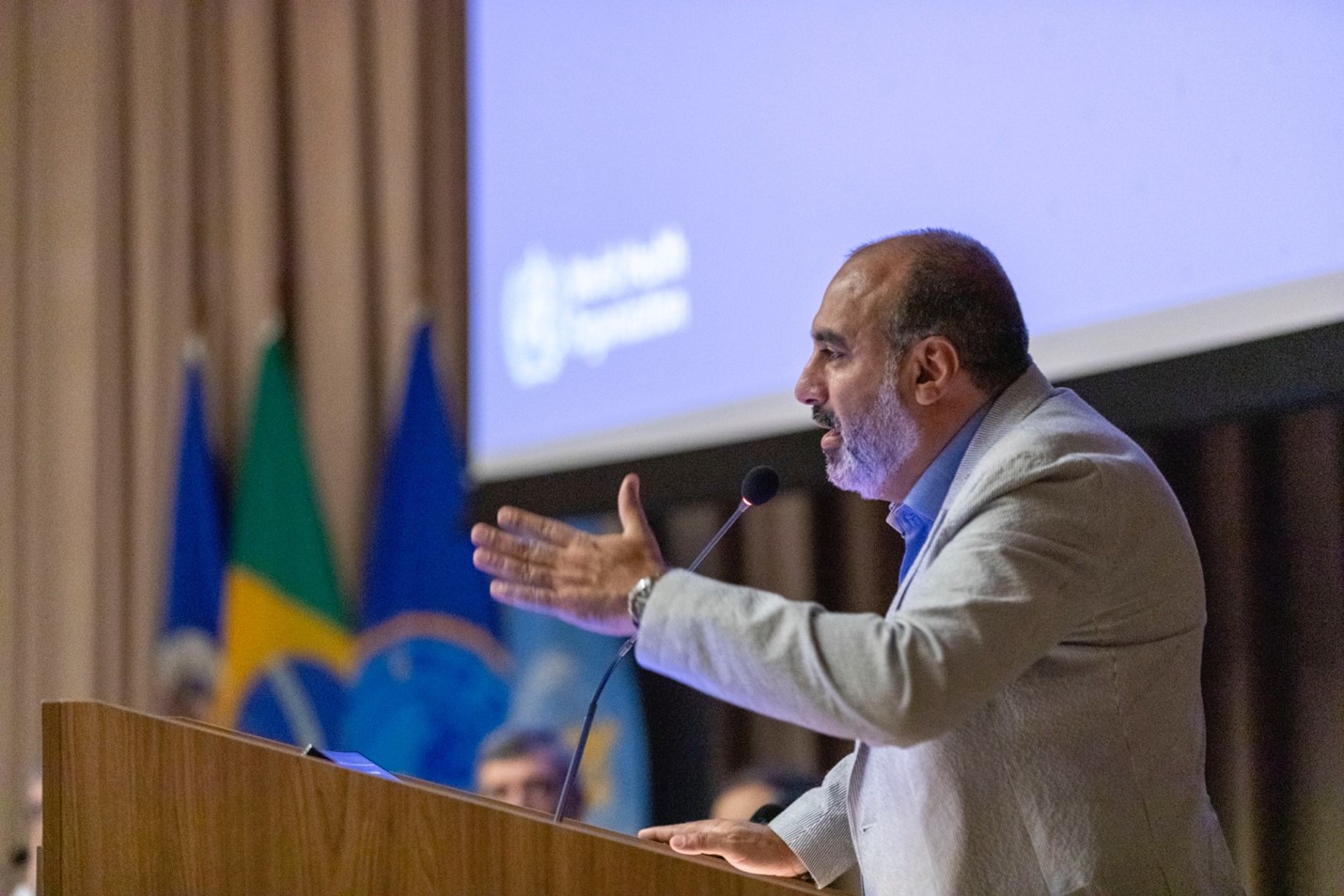 Man in suit addressing an audience