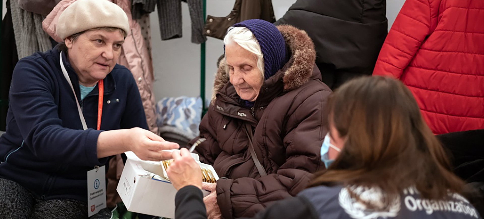 Two women and a WHO worker
