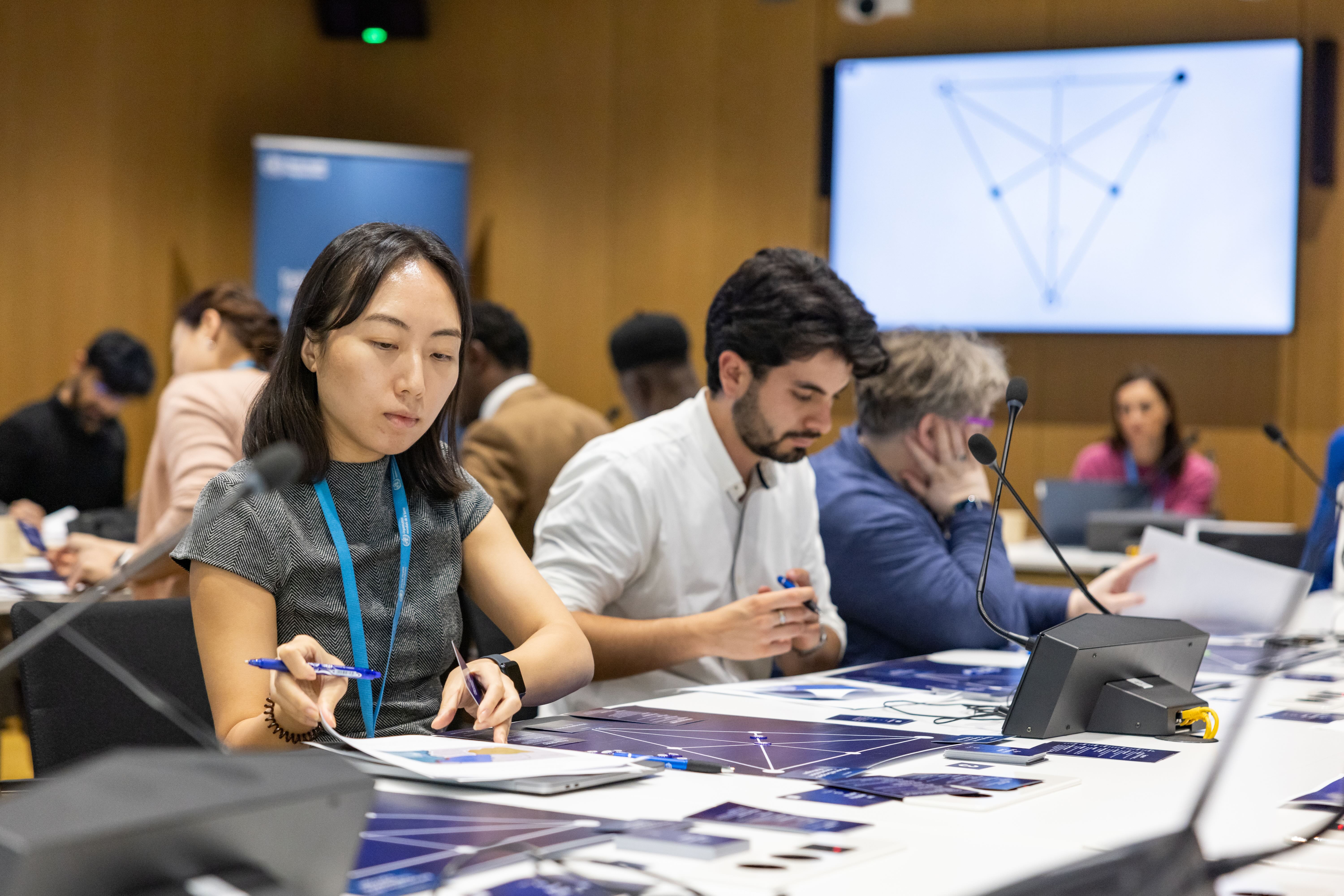 Woman verifying documents in a disease outbreak response meeting