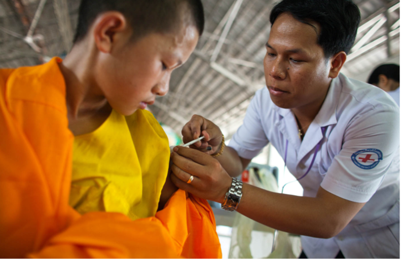 A monk receives a vaccine