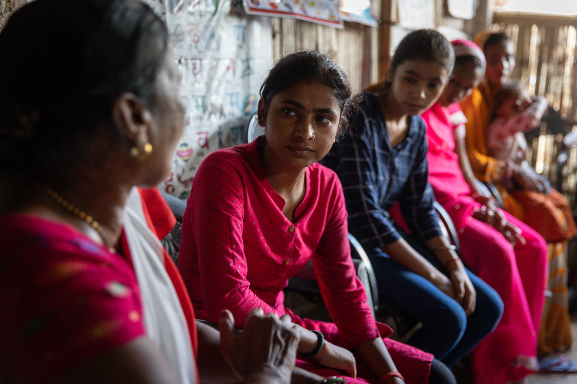At an anganwadi center (government-run daycare center) in Patahi Village of Mushahari Block, Poonam, an auxiliary nurse midwife, counsels Pooja and other young girls from the community on reproductive health and nutrition.