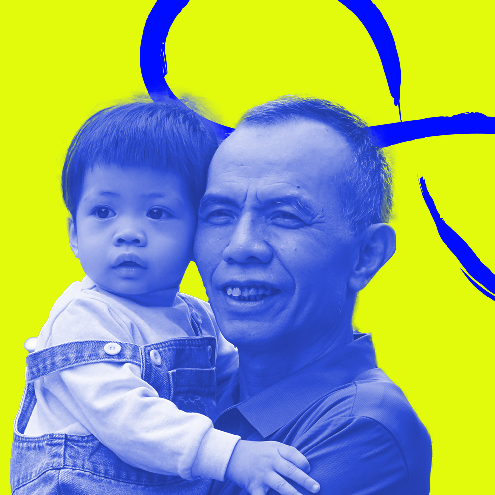 An older man holding a young child. The WHO Global Campaign to Combat Ageism logo is in the background.