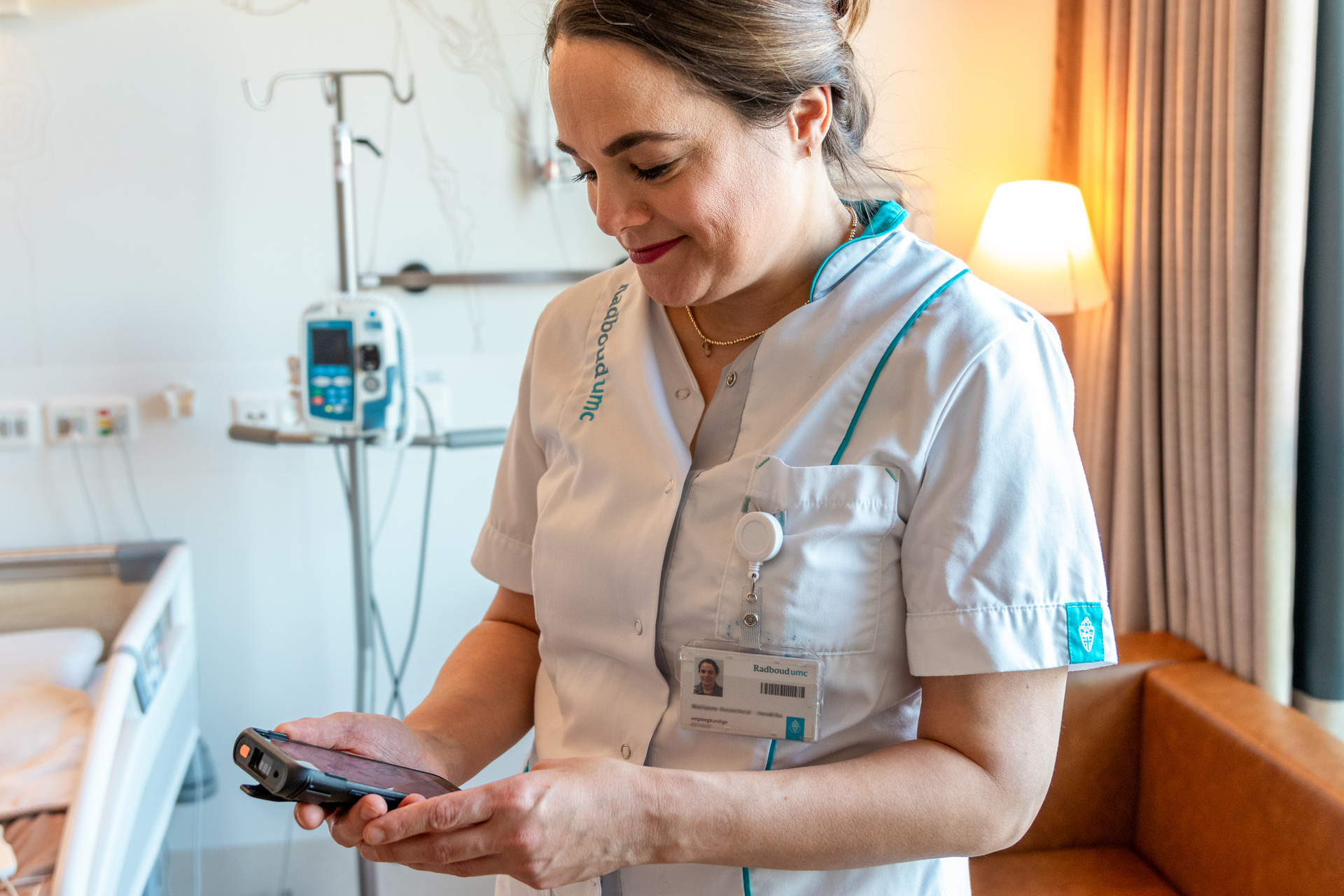 Nurse looking at an electronic device.