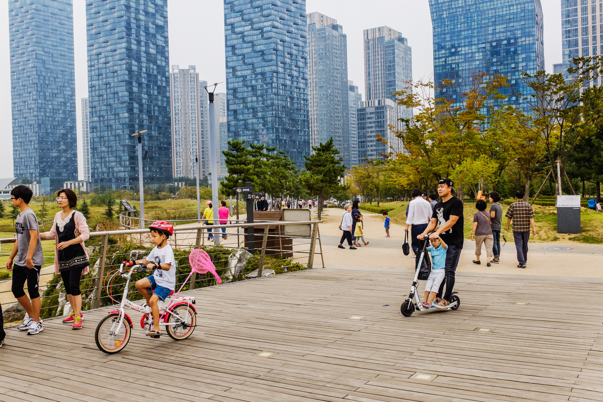 families walking in an urban park