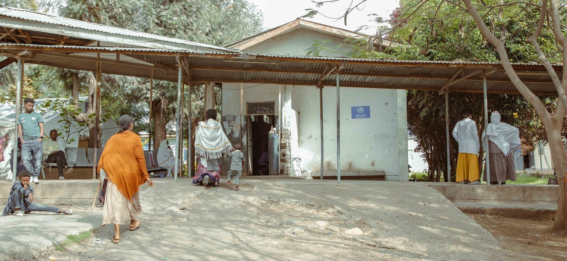 Exterior of Mehoni Primary Hospital on 28 March 2024 with patients waiting or walking