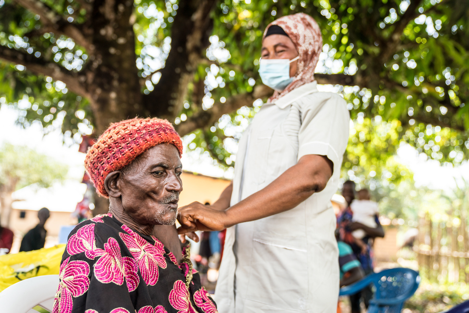 Amara receives his first dose of COVID-19 vaccine from Nurse Kai Koroma in Kamoi, Sierra Leone, on 8 December 2022.