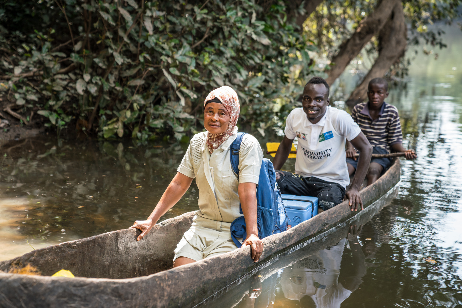 Nurse Kai and community mobiliser Jeremiah sometimes need to use a canoe to reach patients in hard-to-reach communities in Bombali District, Sierra Leone.