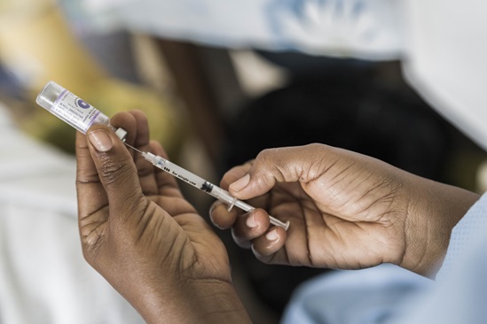 Covid-19-vaccine Hands holding a needle and vial