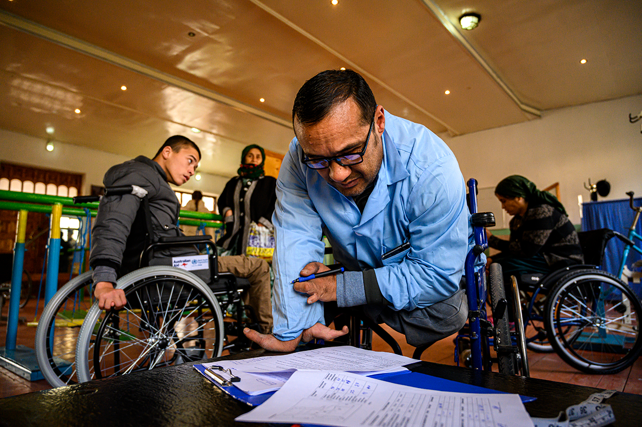 Person in wheelchair filling out a form