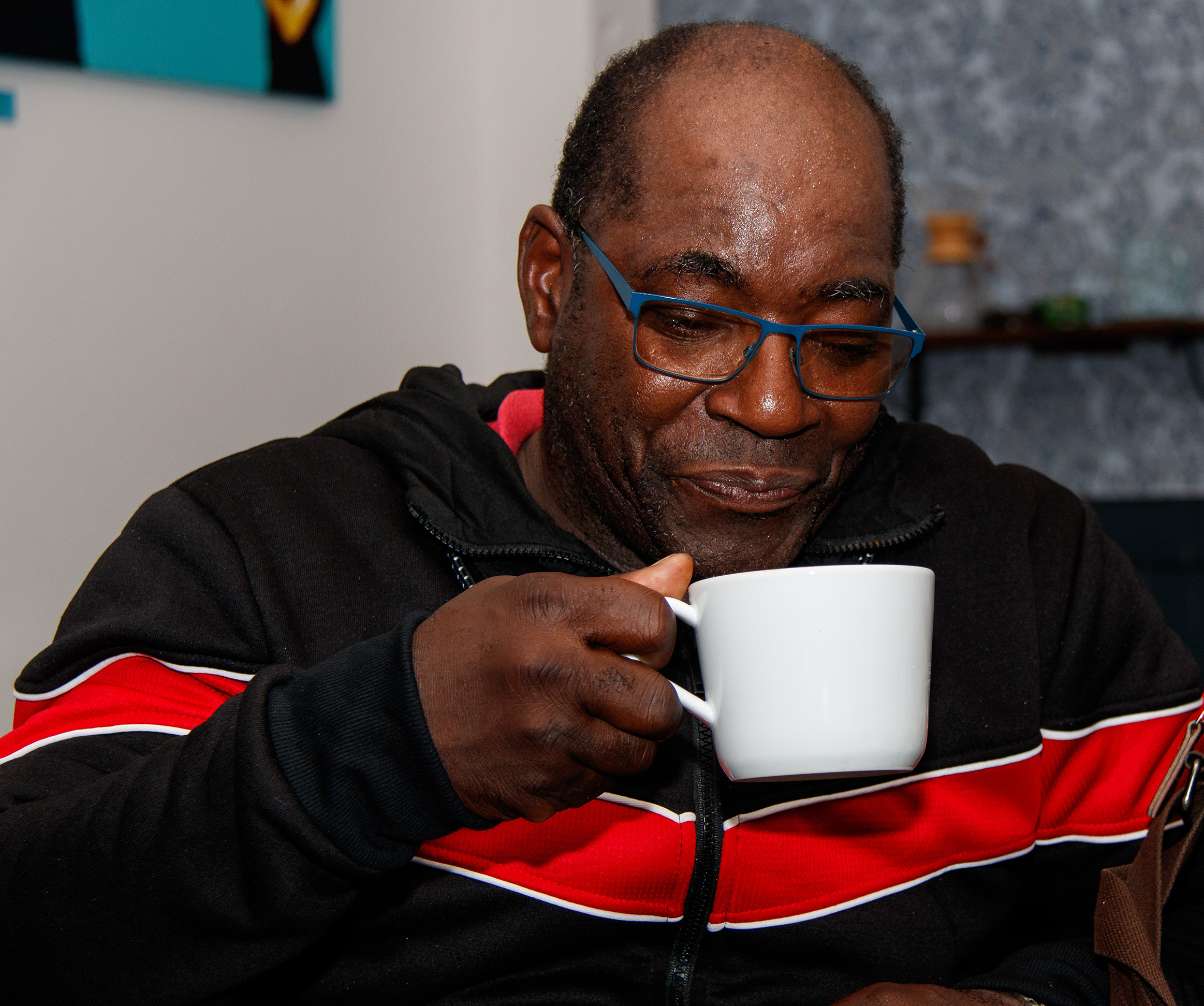 man drinking from a cup.