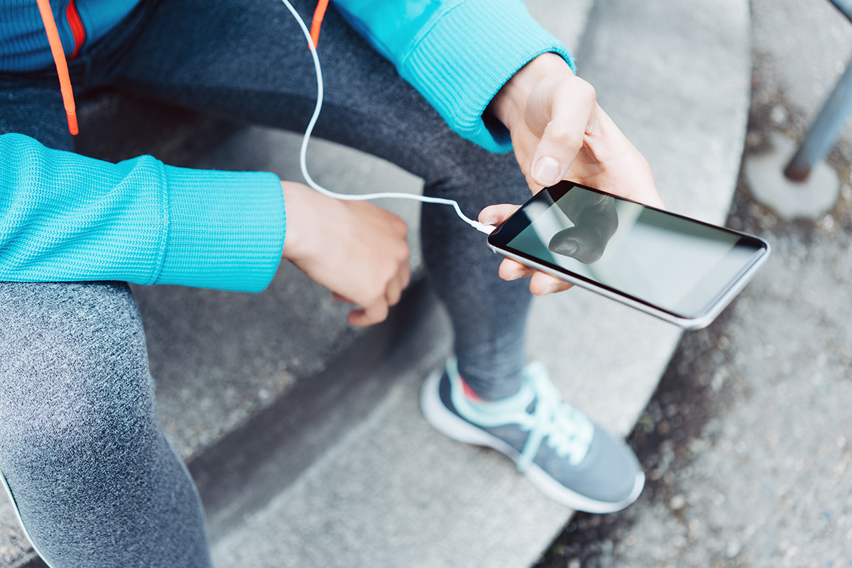 runner using mobile phone for exercise