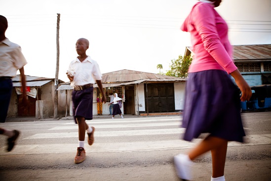 Children crossing a road on pedestrian crossing