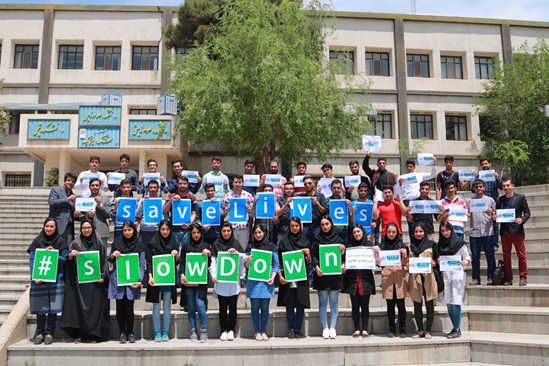 School children and teachers holding signs