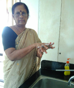 A midwife in India demonstrating hand-washing technique