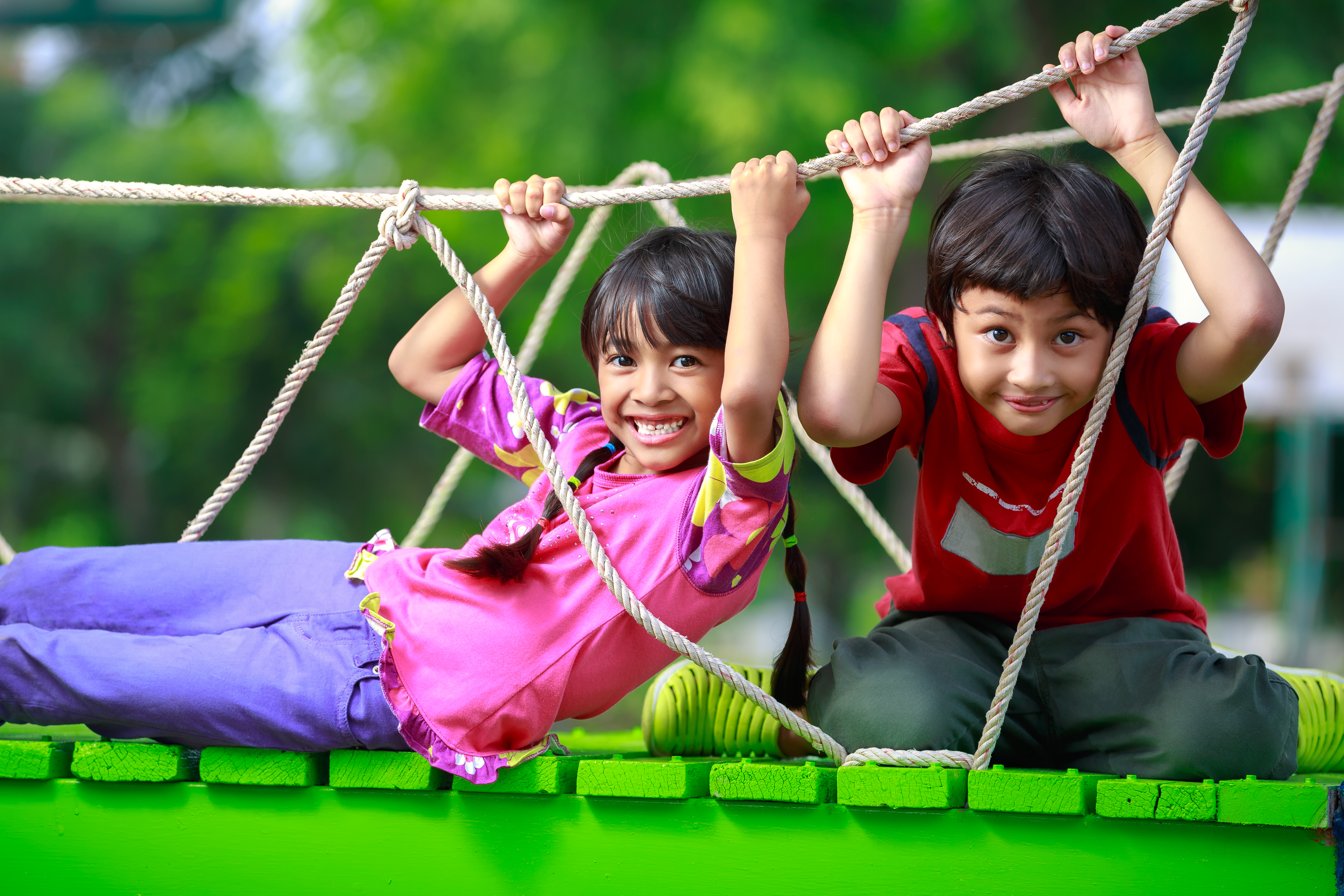 Children playing on a wooden bridge