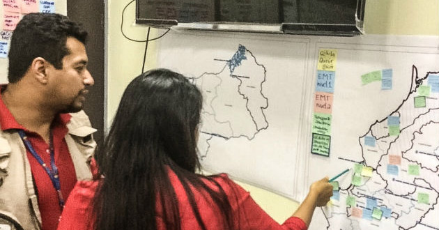 Staff from Ecuador’s Ministry of Health and WHO/PAHO review a map identifying the health facilities affected by the 7.8-magnitude earthquake to coordinate the deployment of Emergency Medical Teams (EMTs) to these areas. 