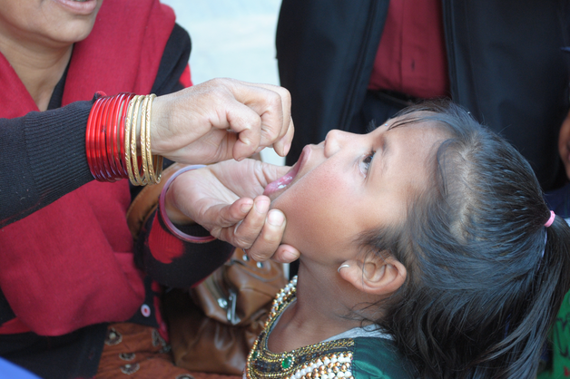 Small boy receives an oral polio vaccine